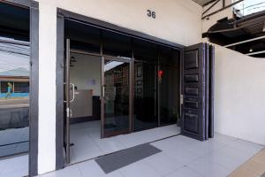 an entrance to a building with sliding glass doors at RedDoorz @ Simpang Pemda Medan in Medan