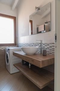 a bathroom with a sink and a washing machine at Waterfront apartment Olbia in Olbia