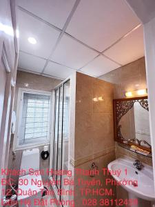 a bathroom with a sink and a mirror at Hoang Thanh Thuy Hotel 1 in Ho Chi Minh City