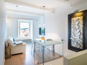 a living room with a glass table and a chair at White dreams in Portovenere