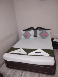 a bedroom with a large bed with pillows at Grand tower Chennai in Chennai