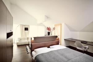 A bed or beds in a room at Hotel Post Bezau