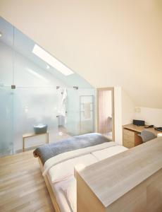 A bed or beds in a room at Hotel Post Bezau