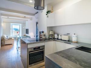 a kitchen with white cabinets and a stove top oven at White dreams in Portovenere