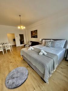 a bedroom with a large bed and a living room at City Center Apartments am Schwedenplatz in Vienna