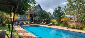 a swimming pool in the backyard of a house at Yellow Haven Lodge in Kampala
