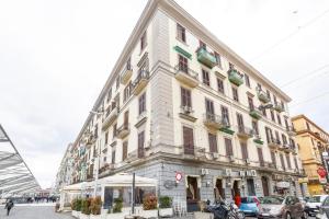 a large white building on the corner of a street at Scaramantico Rooms in Naples