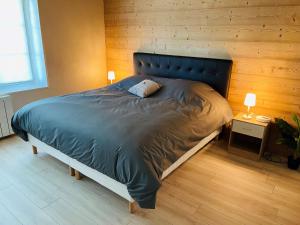 a bedroom with a large bed with a blue comforter at ※ Résidence POMME DE PIN - Terrasse - Nature ※ in Xonrupt-Longemer