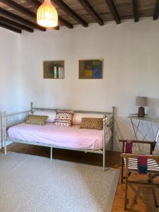 a bed with pillows on it in a room at Tenuta di Corsano in Monteroni dʼArbia