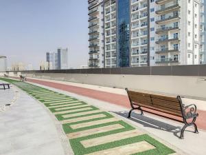 a park bench in a city with tall buildings at Key View Hera Tower in Dubai