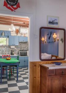 uma cozinha com uma mesa e um espelho em Blue Traditional Boathouse in Klima em Klima