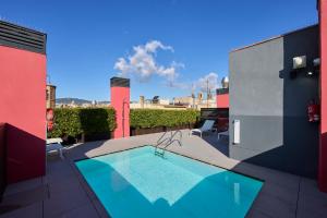 a swimming pool on the roof of a building at Catalonia Avinyo in Barcelona