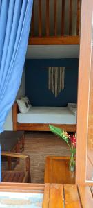 a small bed in a room with a blue wall at Ong Lang Bay Resort in Phú Quốc