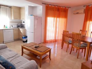 a kitchen and a living room with a couch and a table at EDIFICIO ALGAIDA - NEW VISTA MONTAÑA - PLAYA DE LA CONCHA in Oropesa del Mar