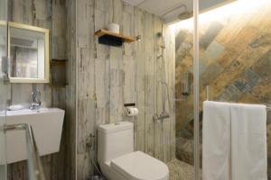 ein Bad mit einem WC, einem Waschbecken und einer Dusche in der Unterkunft Hualien Wow Hostel in Hualien