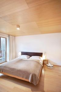A bed or beds in a room at Hotel Post Bezau