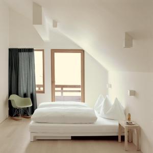 A bed or beds in a room at Hotel Post Bezau