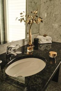 a bathroom counter with a sink and a mirror at Hotel Exel in Amstetten