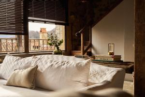 a bed with white pillows in a room with a window at SOLO PALACIO - Boutique Hotel & Spa 