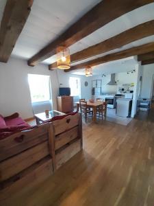 a living room with a bed and a dining room at Les Gîtes de Roucayrols in Pampelonne