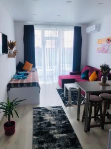 uma sala de estar com um sofá e uma mesa em Sмарт студія з терасою !! em Yuzhne