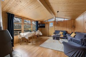 a living room with a blue couch and a table at Lem Cabins in Sogndal