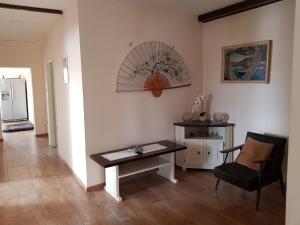a living room with a table and a chair at Apartments Mona Lisa in Raslina