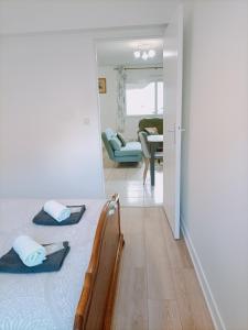 a bedroom with a bed and a living room at FELTON - Appartement 2 pers Dinan in Dinan