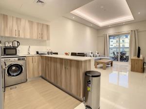 a kitchen with a washer and dryer in a room at Key View Hera Tower in Dubai