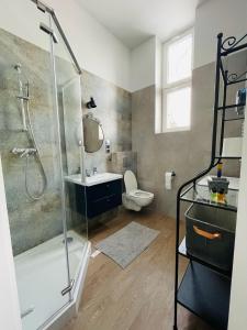 a bathroom with a shower and a sink and a toilet at Pistacjowy - Apartamenty Smart Projekt in Tarnów