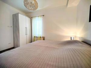 a bedroom with a large bed and a window at Apartments Dajana in Orebić