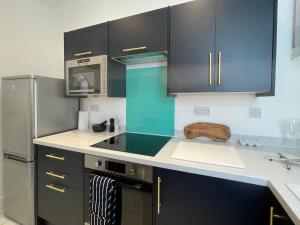 Η κουζίνα ή μικρή κουζίνα στο Top Deck - Fresh, stylish seaside apartment