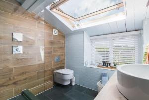 a bathroom with a white toilet and a sink at Rivendell Cottage in Douglas