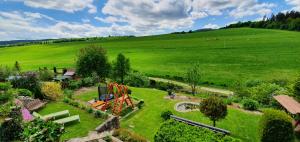 an aerial view of a green field with a park at Chata Family s vírivkou v Slovenskom raji in Spišská Nová Ves