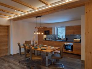 a kitchen and dining room with a wooden table and chairs at Apartment Schönwetter in Großsölk