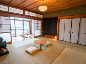 小浜市にあるsea-auberge shitsumi 海のオーベルジュ志積のリビングルーム(テーブル付)が備わり、海の景色を望めます。