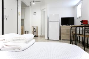 a white room with a bed and a tv at GK Attica in Athens