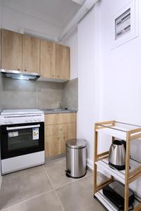 a kitchen with a white stove and a counter at GK Attica in Athens