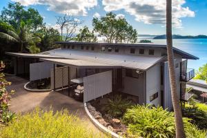 an aerial view of a house with the ocean in the background at The Panorama 3, Hamilton Island 2 Bedroom 2 Bathroom Ocean View Modern Apartment in Hamilton Island
