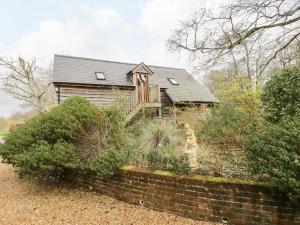 a house with a brick wall in front of it at Avon Turn View in Salisbury