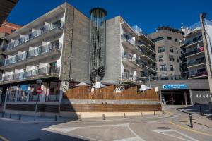 a building with a staircase in the middle of a street at Hotel Acacias Suites & Spa in Lloret de Mar