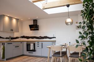 a kitchen and dining room with a table and chairs at Apartment im alten Fronhof in Balingen