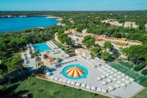 an aerial view of a resort with a pool and a beach at Iberostar Club Cala Barca All Inclusive in Portopetro