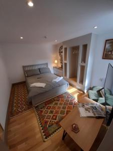 a living room with a bed and a coffee table at cosy quiet apartment in Nottingham