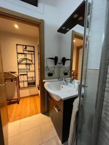 a bathroom with a sink and a shower at Home 10 in Milan