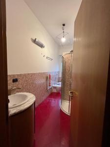 a bathroom with a sink and a shower and a toilet at Home 10 in Milan