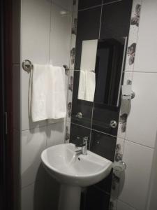 a bathroom with a sink and a mirror and towels at ELSİRA APART in Side