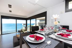 una sala da pranzo con tavolo e vista sull'oceano di RNET - Casa 3 - Vista Mar Almadrava Roses a Roses