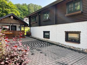 a house with a brick patio in front of it at Appartement zur Wied in Oberlahr