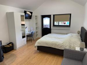 a bedroom with a bed and a desk in it at Appartement zur Wied in Oberlahr
